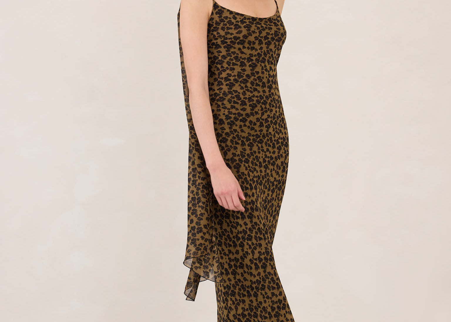 Woman wearing a leopard print dress on a white background