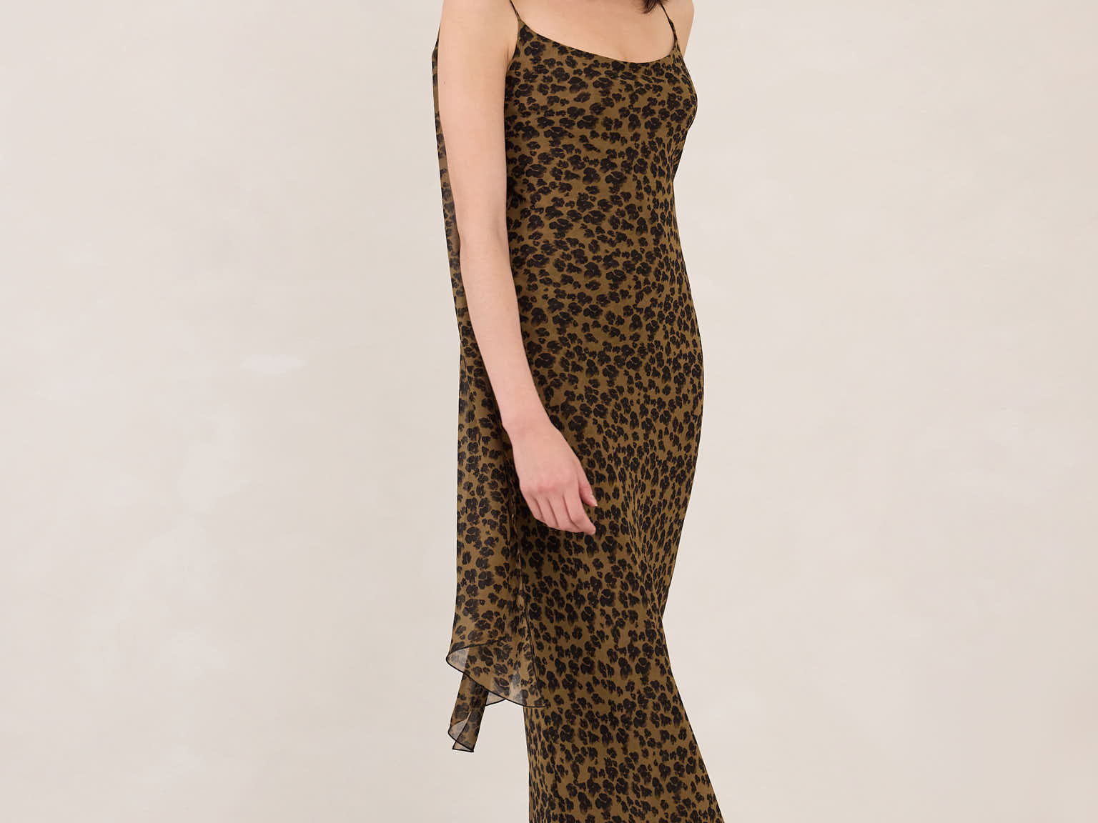 Woman wearing a leopard print dress on a white background