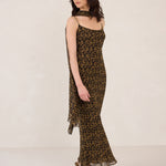 Woman wearing a leopard print dress on a white background