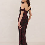 Woman wearing a black and dark red floral off-shoulder gown on a white background
