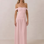 Woman wearing a pink off-shoulder chiffon gown against a plain background