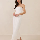 Woman wearing a strapless lace maxi dress on a plain background